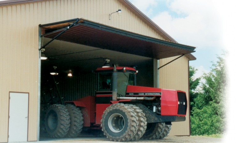 Red Tractor leaving Hangar with Bi-fold Door