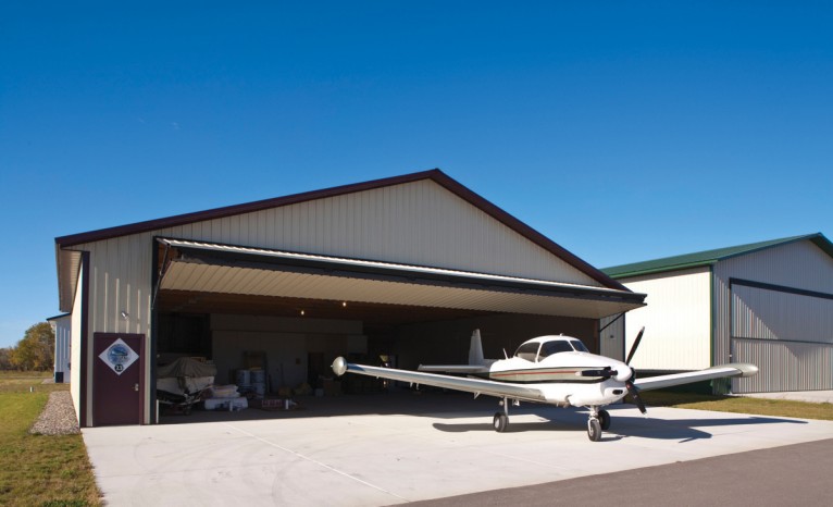 Airplane leaving Bi-Fold Door hangar